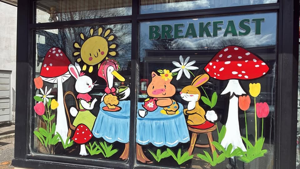 Hand-painted left front window — a bunny, duck, and pig sharing a breakfast tea party